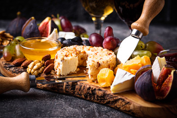 Cheese plate with grapes and wine