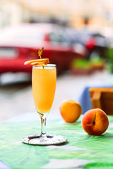 Bellini cocktail atanding on the table at bar's terrace outdoor in the downtown