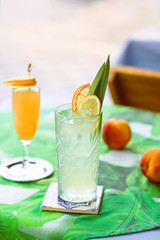 Lemonade and Bellini cocktail standing on the table at bar's terrace outdoor in the downtown
