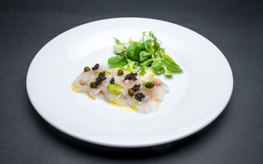 Fresh fish carpaccio with black sturgeon caviar