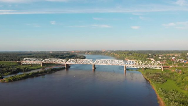 Railway bridge over the river Vyatka in central Russia. a passenger train crosses the river on a bridge.