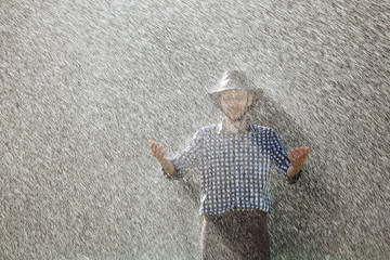 man wet under rain farmer hat enjoy prayer happy upset heavy wet water shower sun summer pray