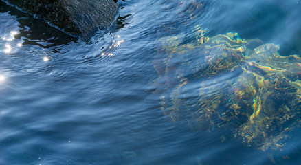 Colorful rocks submerging in the sea water