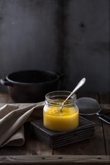 A jar of ghee or clarified butter, copy space