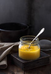A jar of ghee or clarified butter, copy space