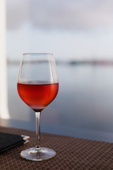 Glass of rose wine closeup on table