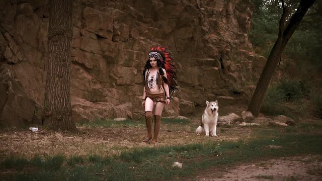 Sexy, wild Indian girl. Background rock, tropics, jungle. Suit from the skin