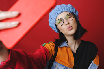 Stylish woman taking selfie