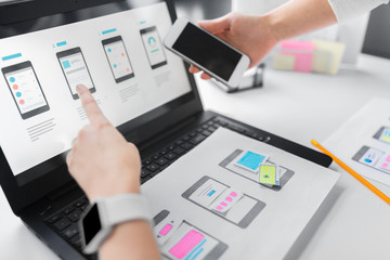 app design, technology and business concept - web designers or developers with laptop computer and...