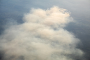 Fototapeta na wymiar Aerial view of smoldering moor fire ignited by training activites on an army shooting range causing large smoke plumes