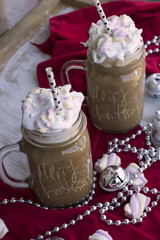 A delicious chocolate drink with tasty marshmallows on a christmas theme.