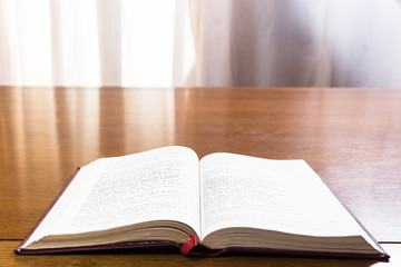 Hard cover books organized over wooden table