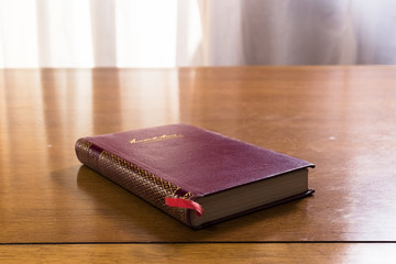 Hard cover books organized over wooden table