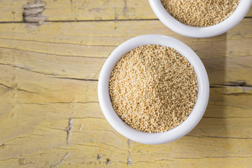 amaranth beans in bowl, on rustic wooden background