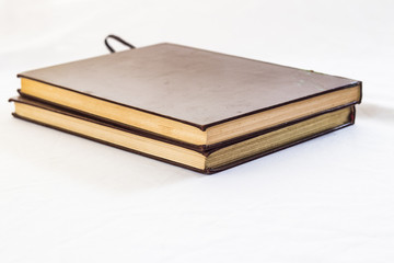 Hard cover books organized over wooden table