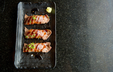 Top view of sushi r premium beef grilled, sushi wakyu on black dish. image for background, wallpaper, copy space and menu list.