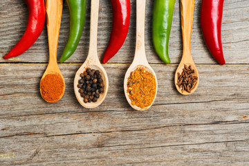chili pepper, Various spices on old wooden, room for text. toned image. light effects 