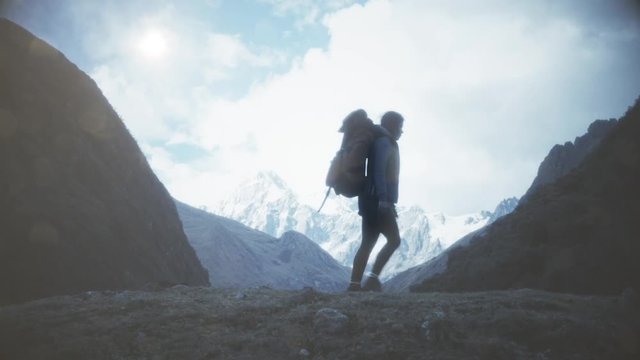 Womam traveler hiking with backpack at rocky mountains landscape. Travel Lifestyle concept.