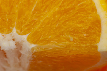 Fototapeta na wymiar Flesh of juicy ripe orange as background or backdrop, close-up abstract blurred image