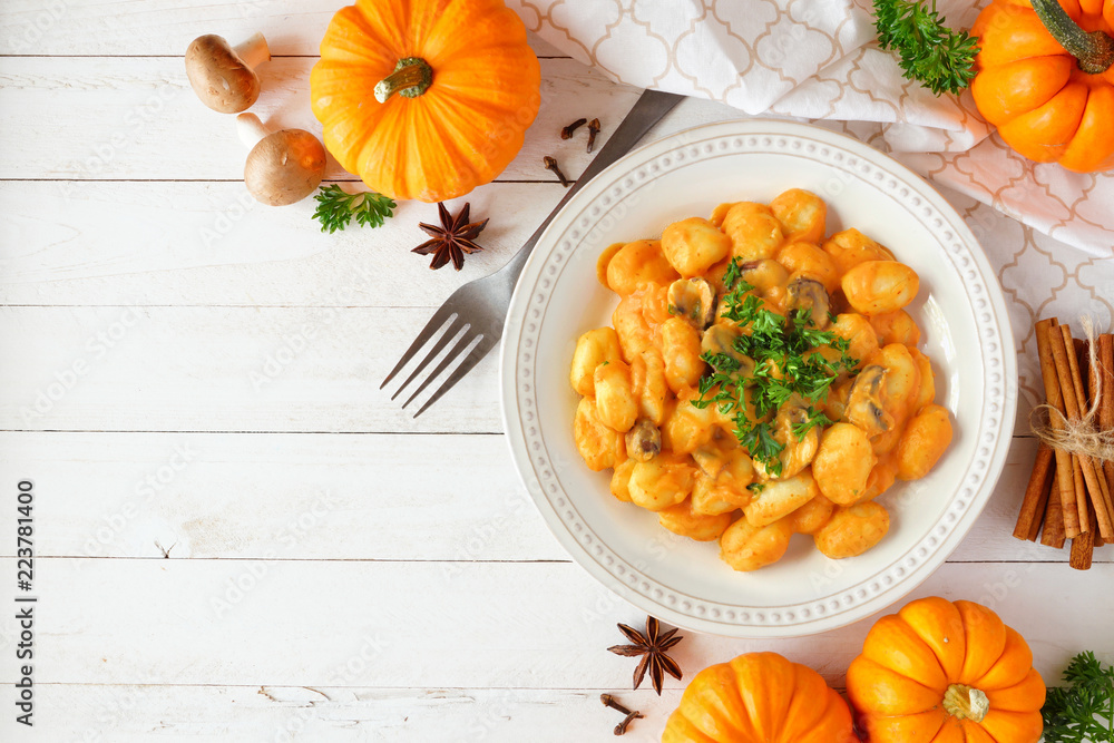 Wall mural Gnocchi with a pumpkin, mushroom cream sauce. Autumn meal. Top view table scene on a white wood background with copy space. - Wall murals