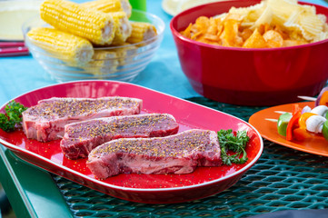 Uncooked New York Steak with Sides
