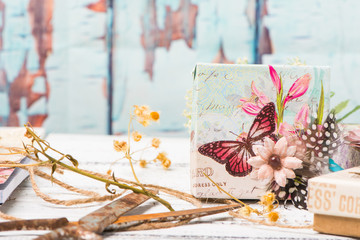 Decorative gift box with feather and butterfly and rustic decorations
