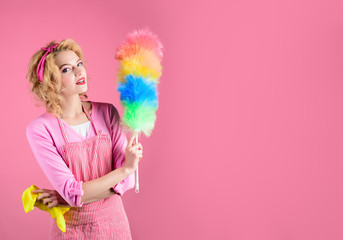 Hygiene concept. Happy girl hold colorful duster brush and rag. Cleaning service. Girl cleaner with...
