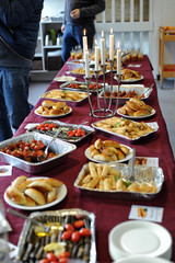 Various dishes on a wooden table served in traditional interior Middle Eastern restaurant atmosphere