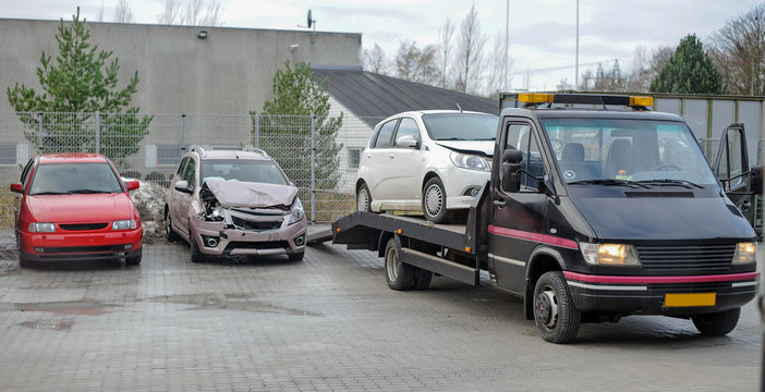 Broken car on tow truck after traffic accident