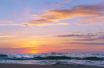 Fototapeta premium Sunset over the sea. Reflection of sunlight in the sea waves. Red sky in the rays of the sunset.