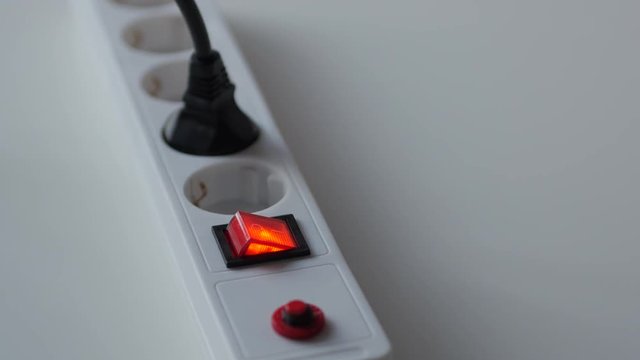 Male Finger Turn On Switch Of Electricity Extension Cord