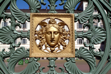Turin, Piedmont, Italy particular of the gate of the Royal Palace with golden Medusa symbol embossed.