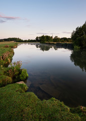 Fototapeta na wymiar Beautiful dawn landscape image of River Thames at Lechlade-on-Thames in English Cotswolds countryside