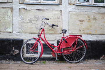 Retro vintage red bike on street in the old town.