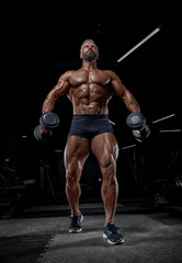 Fototapeta na wymiar Brutal adult athlete posing in the gym.