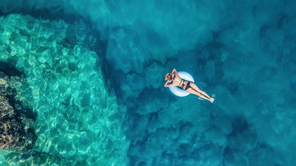 Aerial view at the girl on sea. Turquoise water from air as a background from air. Natural seascape...