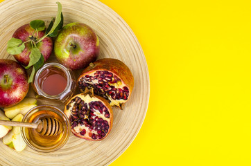Rosh hashanah (jewish holiday) concept. Honey, apple and pomegranate on wooden dish