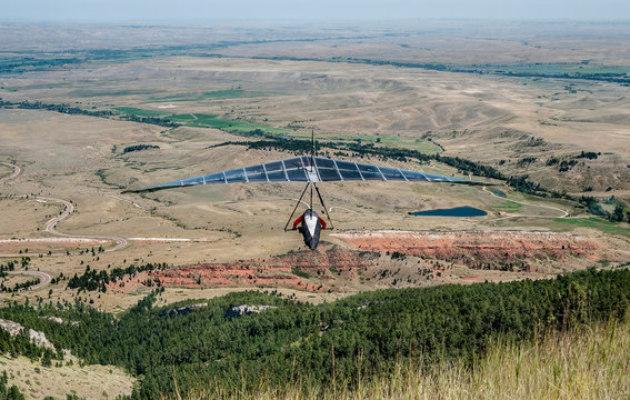 Hang Gliding In Wyoming:  A Glider Sails Over The Landscape Of Northeast Wyoming After Launching From A Roadside Cliff In The Big Horn Mountains.