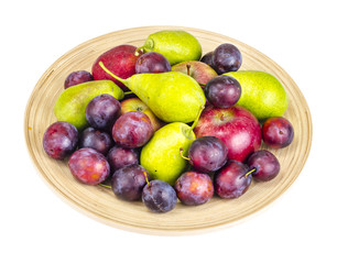 Ripe fruit on wooden plate