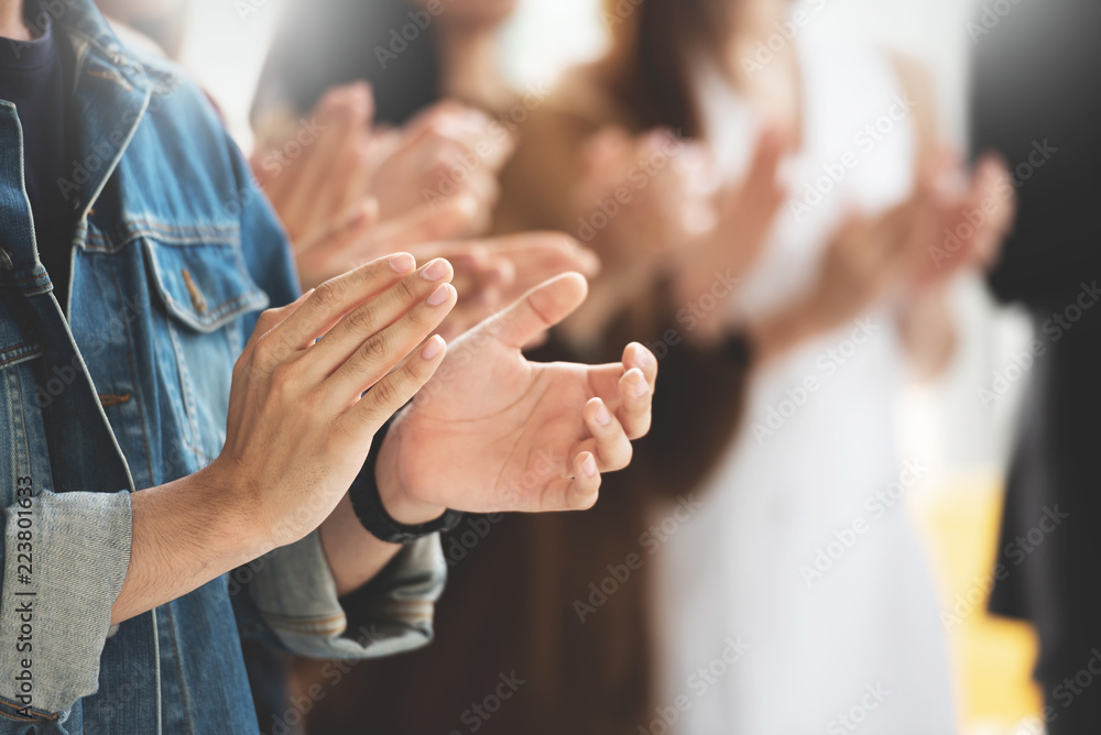 Wall mural cropped image of creative designers audience applauding at a business seminar.