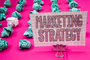 Conceptual hand writing showing Marketing Strategy. Business photo showcasing Plan Formula Creativity Research Organization Paperclip with pink letters pink ground green paper lobs