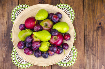 Ripe fruit on wooden plate
