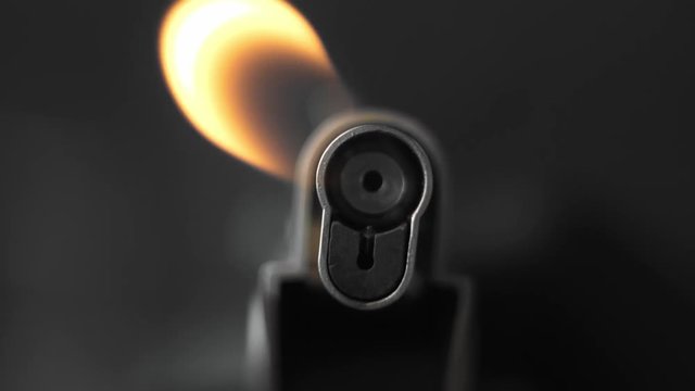 Chef uses a lighter. Gas Lighter with Flame. Fire.