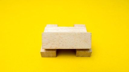 wood block on yellow background 