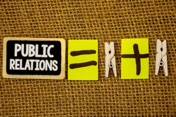 Conceptual hand writing showing Public Relations. Business photo showcasing Communication Media People Information Publicity Social White text black paint wood board equal wodden clip