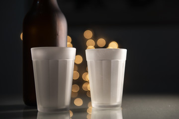 glass cup and a beer bottle