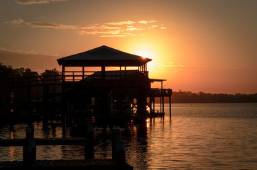 pier and cabana at sunset on the river