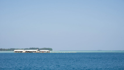 a floating house traditional with blue sea and clear sky with wood and bamboo material