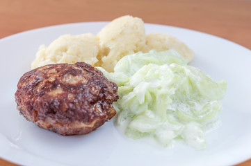Polish Meatballs knows in Poland as kotlet mielony with mizeria and mashed potatoes. - obrazy, fototapety, plakaty