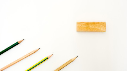 pencil isolated on white background with wooden block copyspace